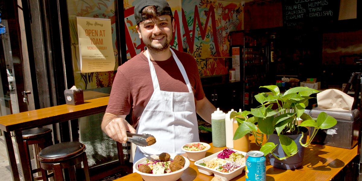 Chef Eli and food Image of chef at table of prepared food
